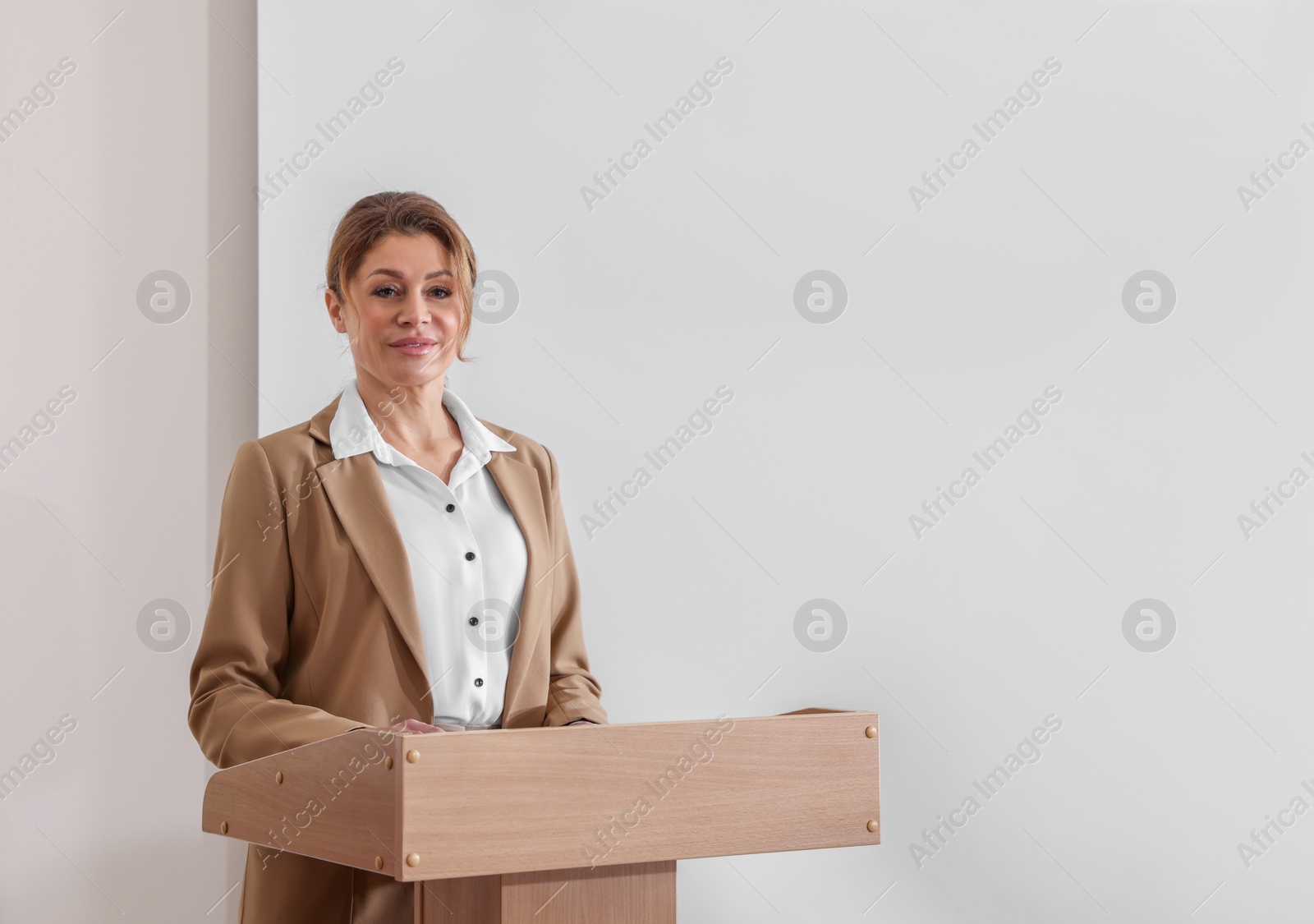 Photo of Business trainer giving lecture in conference room with projection screen. Space for design