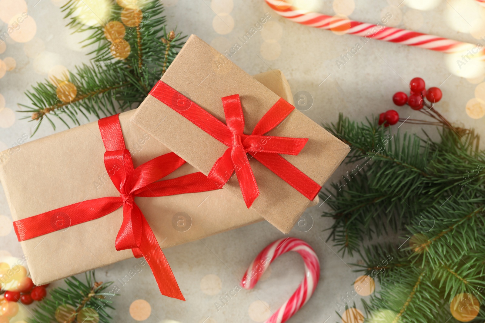 Photo of Flat lay composition with Christmas gift boxes and decor on light table