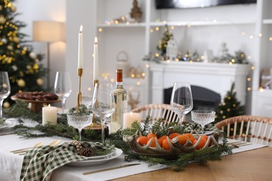 Christmas table setting with festive decor and dishware in living room