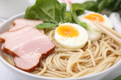 Photo of Delicious ramen with meat in bowl, closeup. Noodle soup