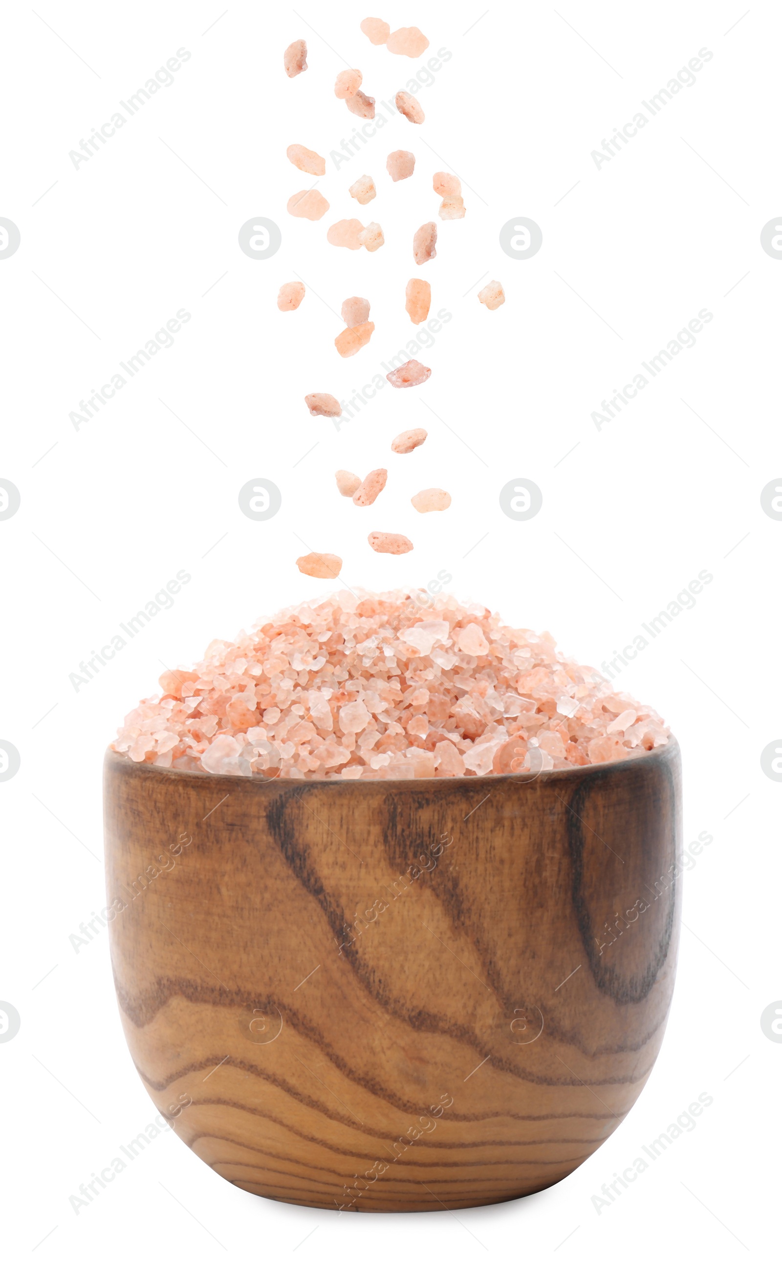 Image of Pink himalayan salt falling into bowl on white background