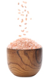 Pink himalayan salt falling into bowl on white background