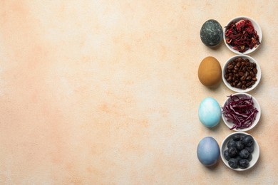 Photo of Painted Easter eggs with natural organic dyes (hibiscus, coffee beans, beetroot and blueberries) on light table, flat lay. Space for text