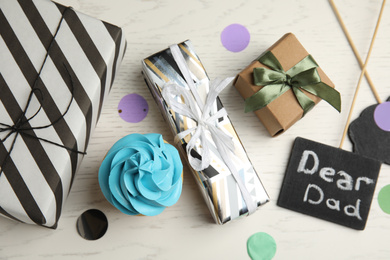 Photo of Flat lay composition with gift boxes on white table. Happy Father's day