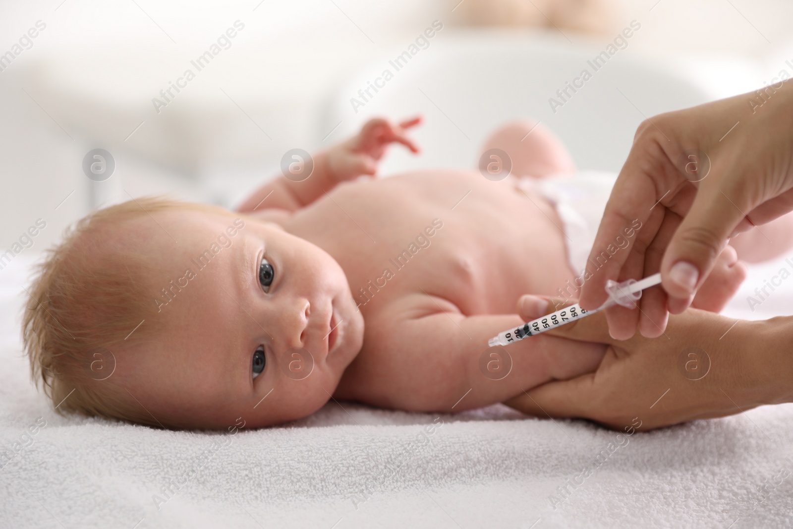 Photo of Doctor vaccinating cute baby, closeup. Health care