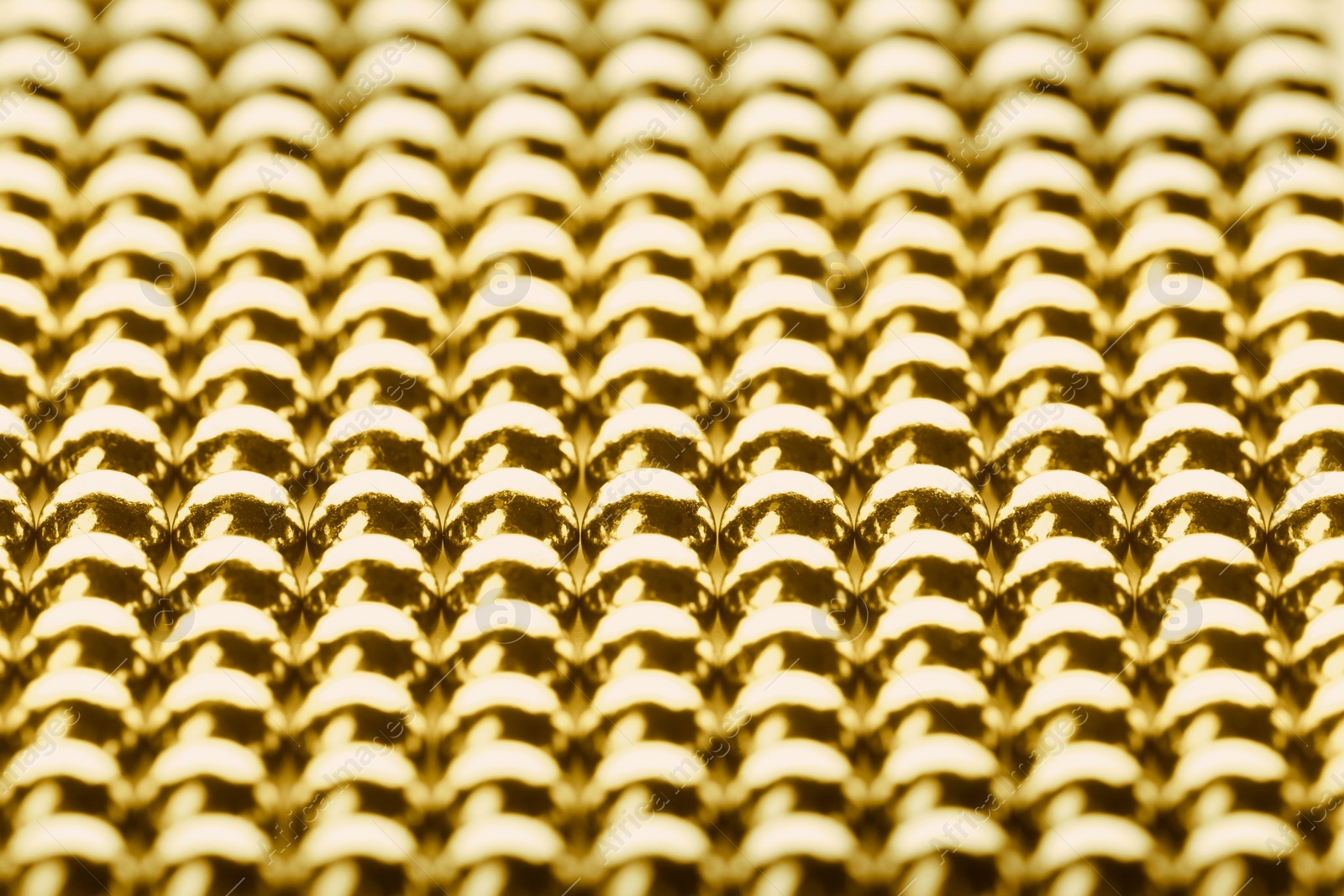 Image of Small golden magnetic balls as background, closeup