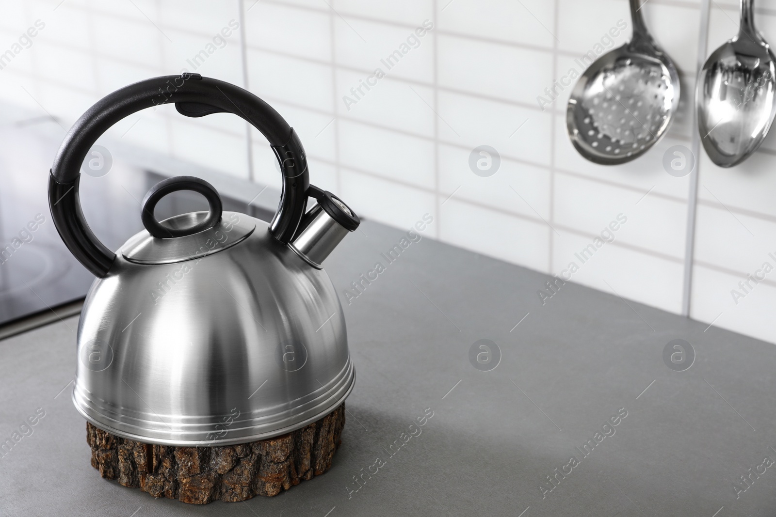 Photo of Modern kettle on kitchen counter indoors, space for text
