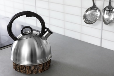 Modern kettle on kitchen counter indoors, space for text