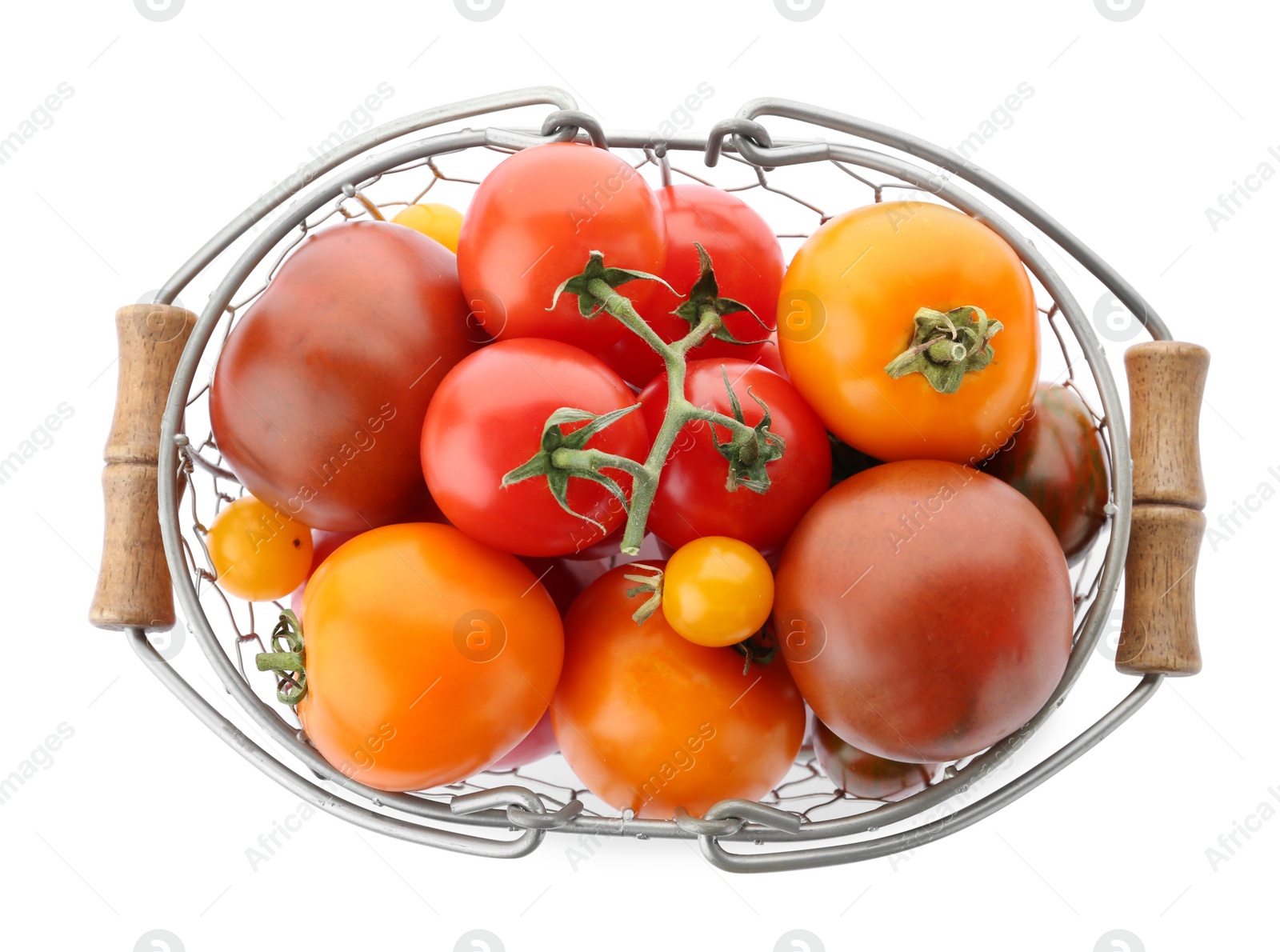 Photo of Top view of fresh ripe yellow and red tomatoes in metal basket on white background