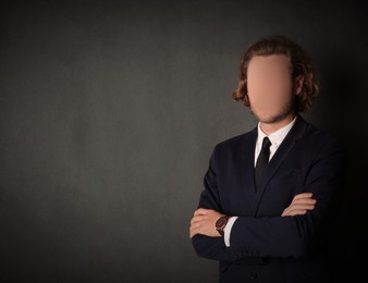 Anonymous. Faceless man in suit near grey wall, space for text