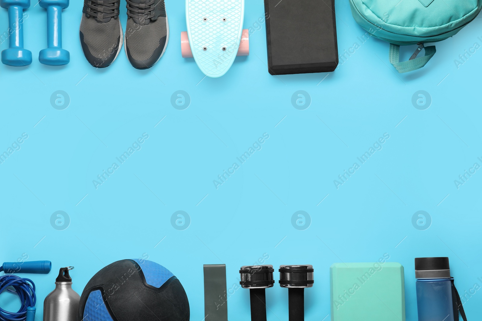 Photo of Frame made of different sports equipment on light blue background, flat lay. Space for text