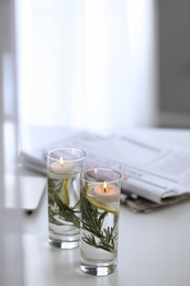 Photo of Natural homemade mosquito repellent candles on white table indoors