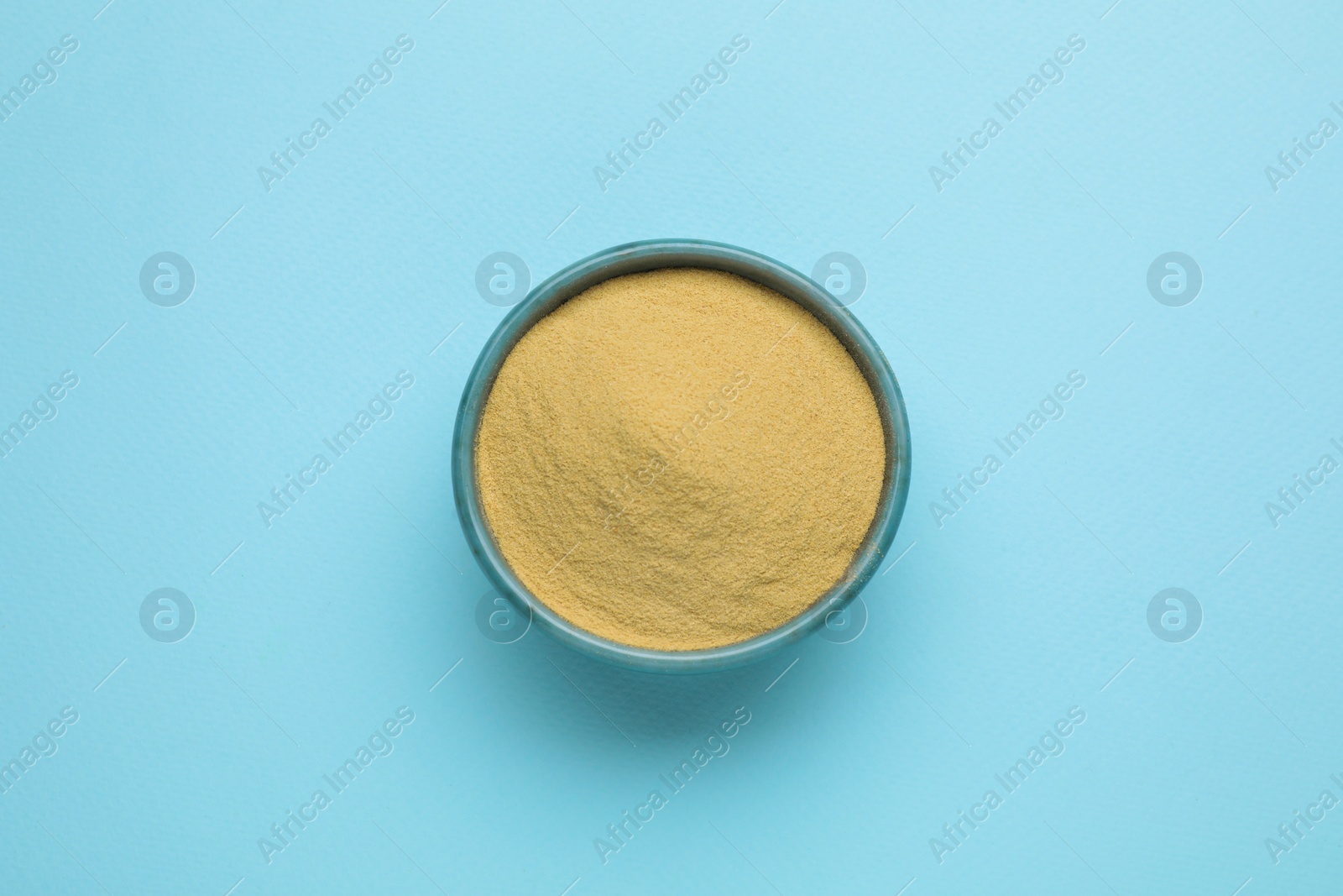Photo of Beer yeast powder on light blue background, top view