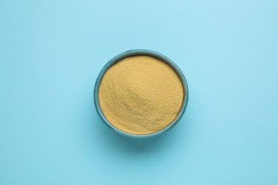 Beer yeast powder on light blue background, top view