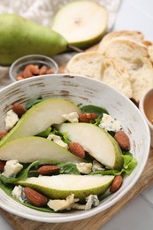 Photo of Delicious pear salad in bowl on table, closeup