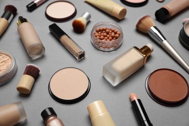 Photo of Face powders and other makeup products on grey background