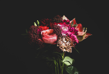 Photo of Beautiful bouquet of different flowers on black background. Floral card design with dark vintage effect