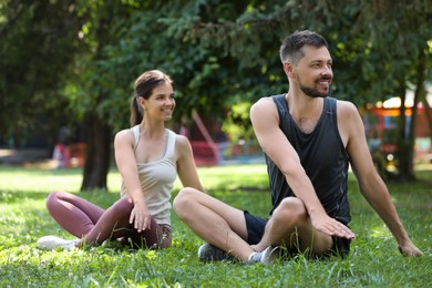 Man and woman doing morning exercise in park