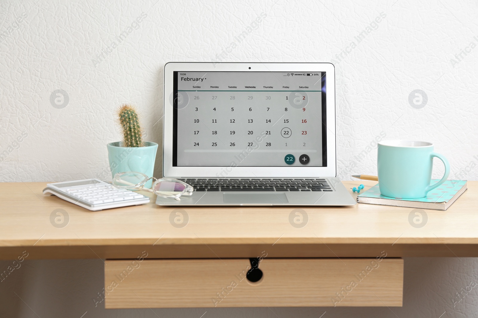 Photo of Modern laptop with calendar app in office