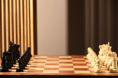 Photo of Chessboard with game pieces indoors, space for text