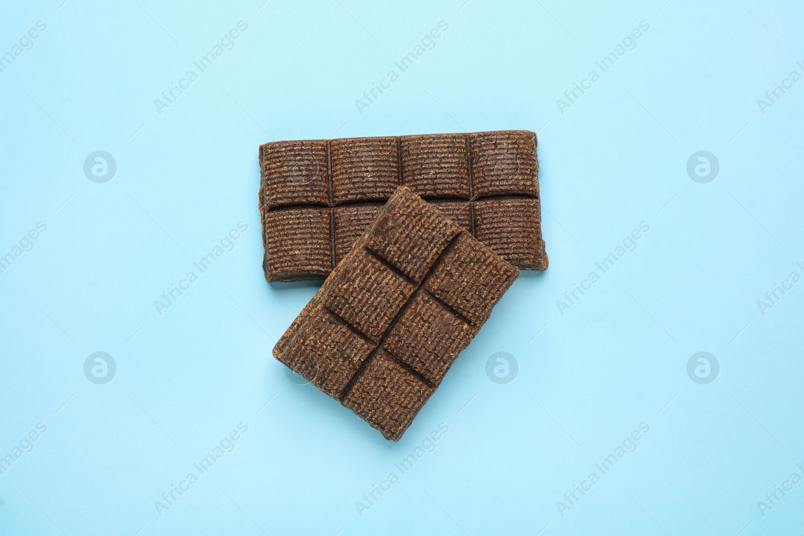 Photo of Hematogen bars on light blue background, flat lay