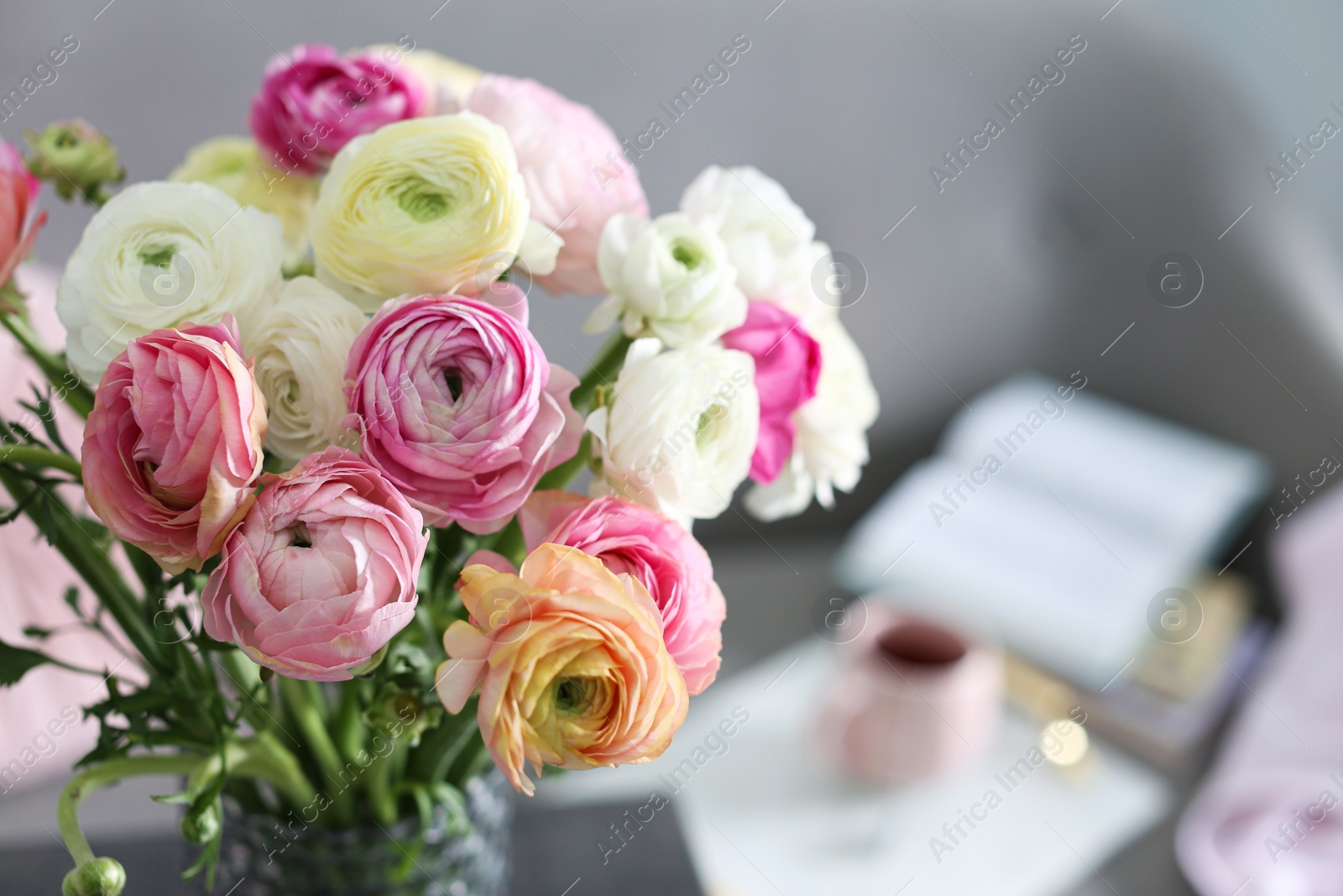 Photo of Bouquet of beautiful ranunculuses in living room