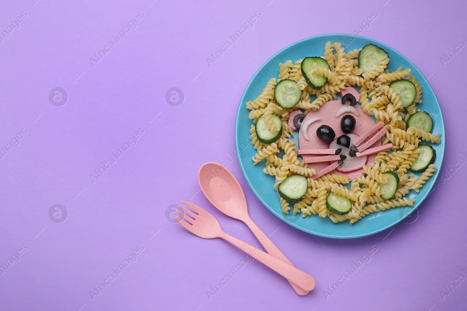 Photo of Creative serving for kids. Plate with cute bear made of tasty pasta, vegetables and sausage on violet background, flat lay. Space for text