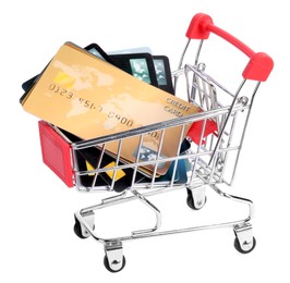 Photo of Small metal shopping cart with credit cards isolated on white