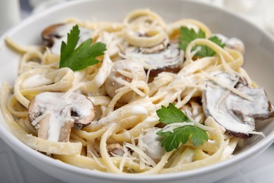 Photo of Delicious pasta with mushrooms in bowl, closeup