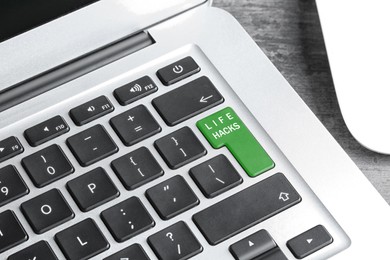 Image of Green button with words Life Hacks on laptop, closeup