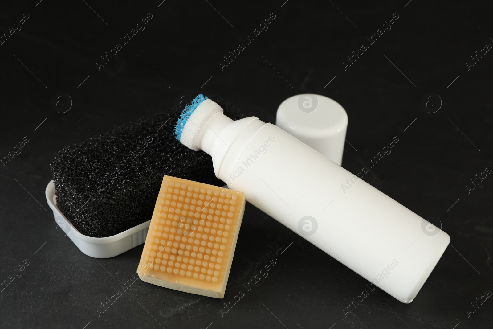 Photo of Composition with shoe care accessories on black background, closeup