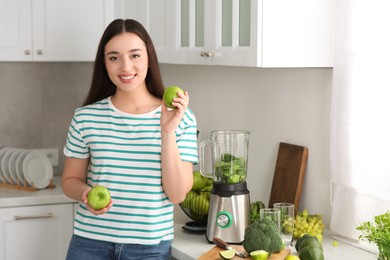 Photo of Beautiful young woman with apples for smoothie in kitchen