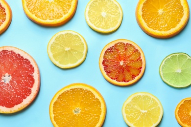 Photo of Different citrus fruits on color background, flat lay