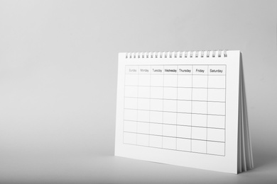 Photo of Blank paper calendar on grey background, space for text. Planning concept