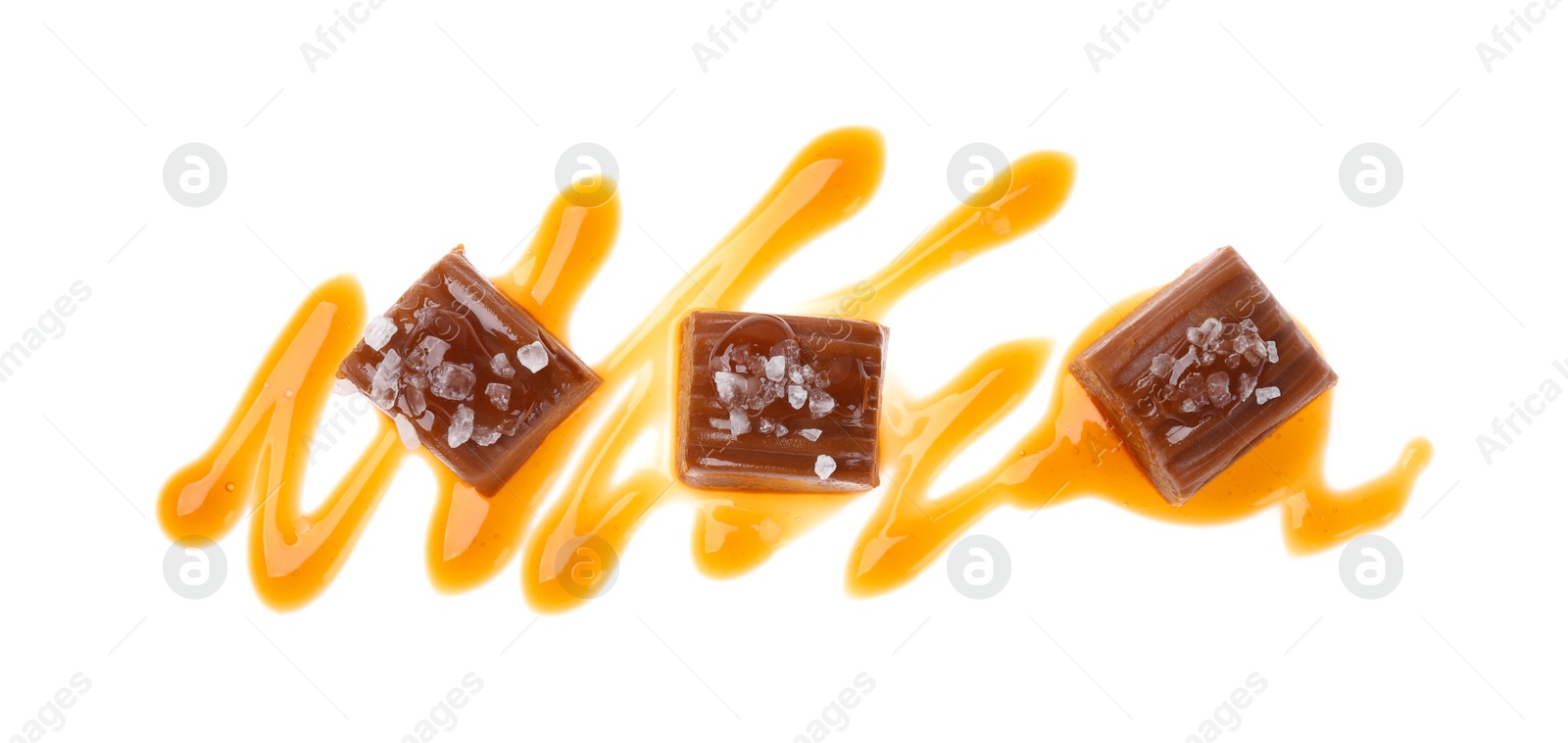 Photo of Delicious salted caramel with sauce on white background, top view