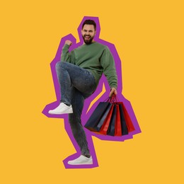 Image of Happy man with shopping bags on orange background