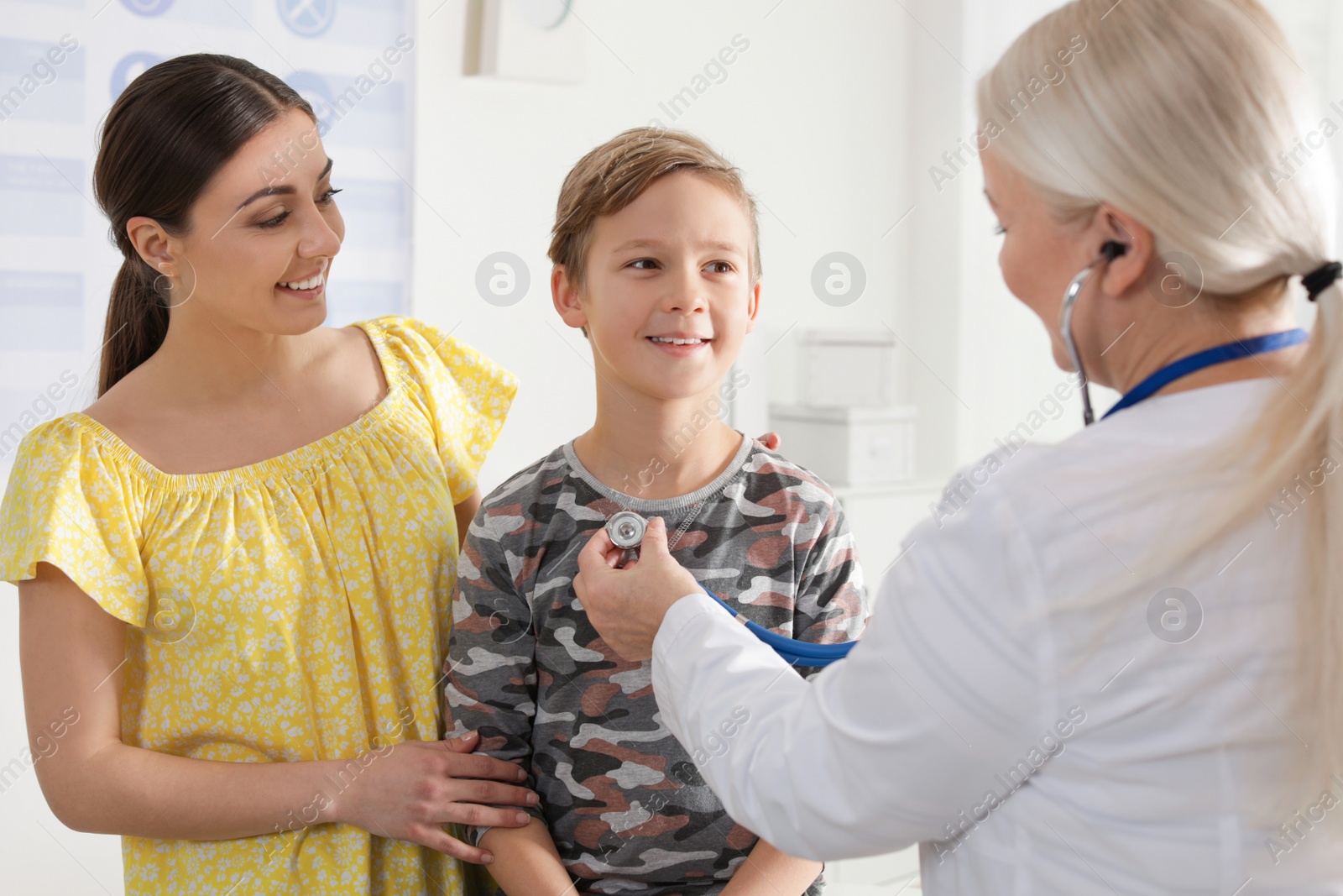 Photo of Mother with child visiting doctor in hospital