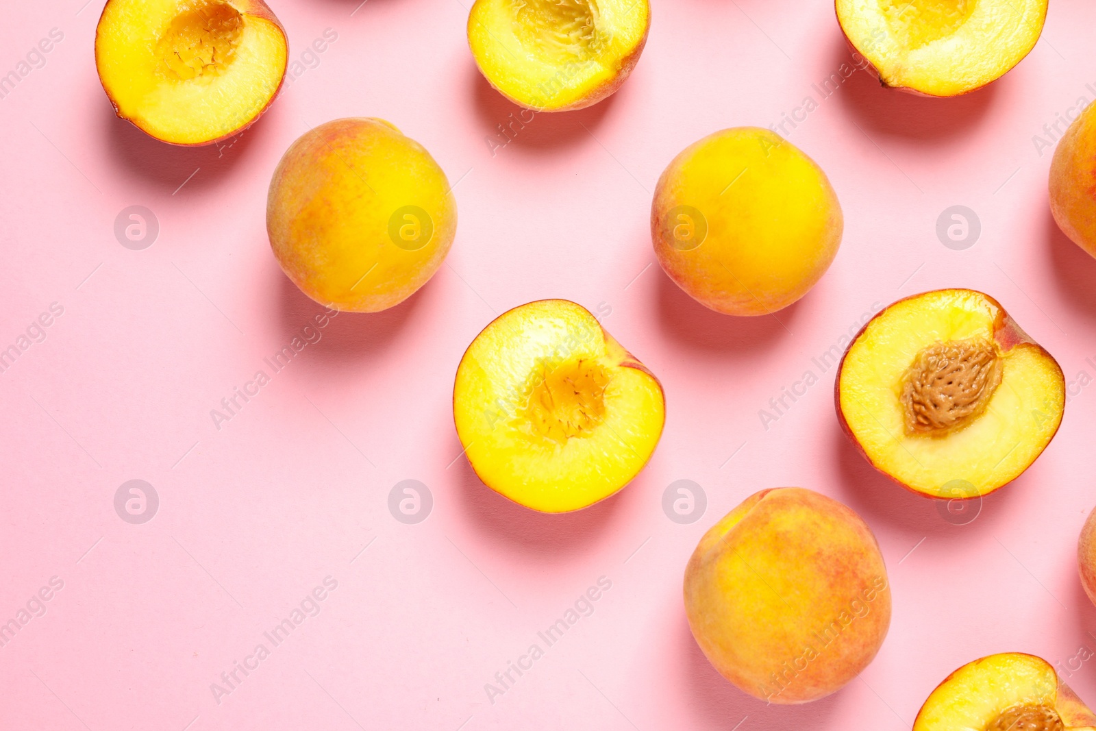 Photo of Flat lay composition with ripe peaches on color background