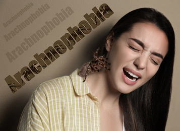 Image of Scared woman with tarantula on beige background. Arachnophobia (fear of spiders)
