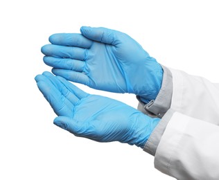 Doctor wearing light blue medical gloves holding something on white background, closeup