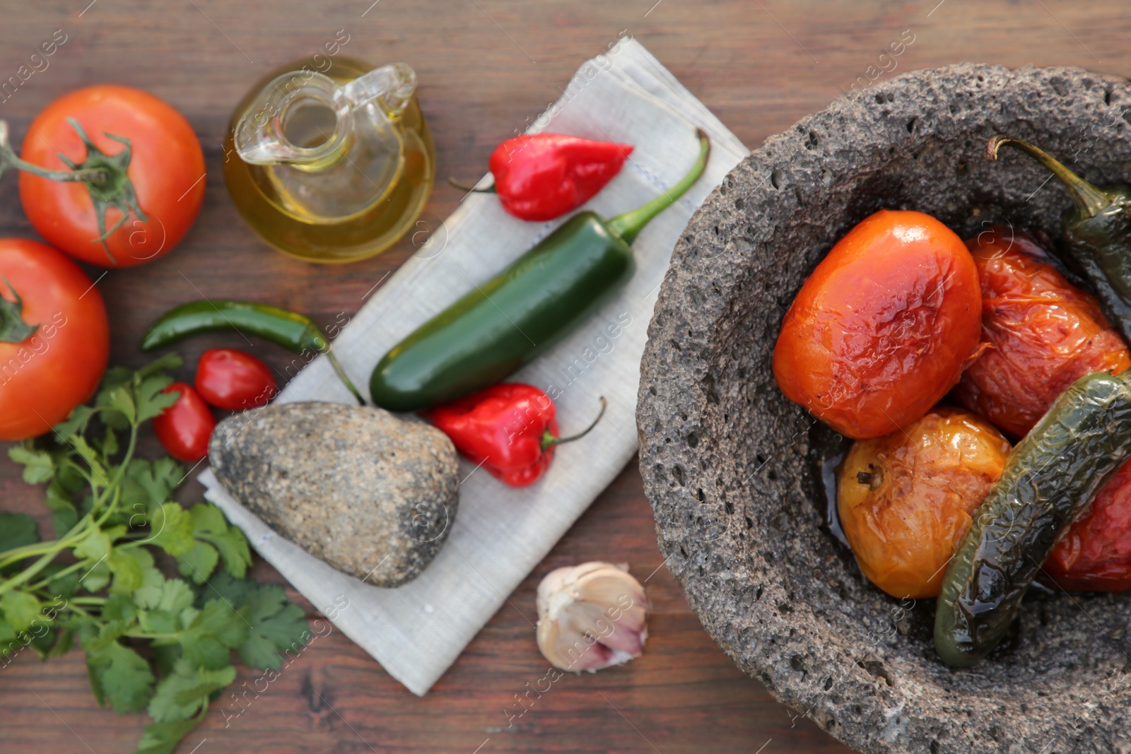 Photo of Ingredients for tasty salsa sauce, pestle and mortar on wooden table, flat lay