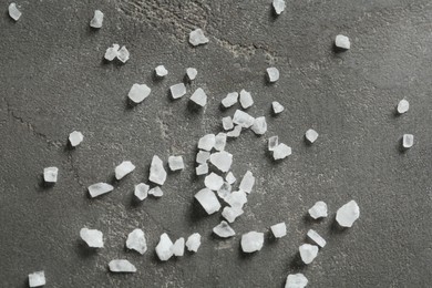 Photo of Natural sea salt on grey table, flat lay