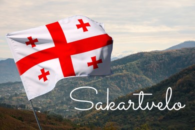 Image of Word Sakartvelo meaning native name of Georgia near its national flag against beautiful mountain landscape