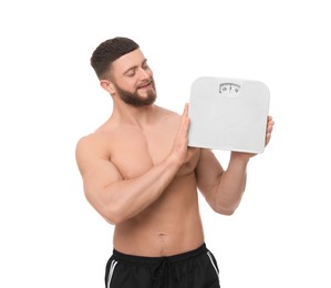 Photo of Athletic man with scales on white background. Weight loss concept