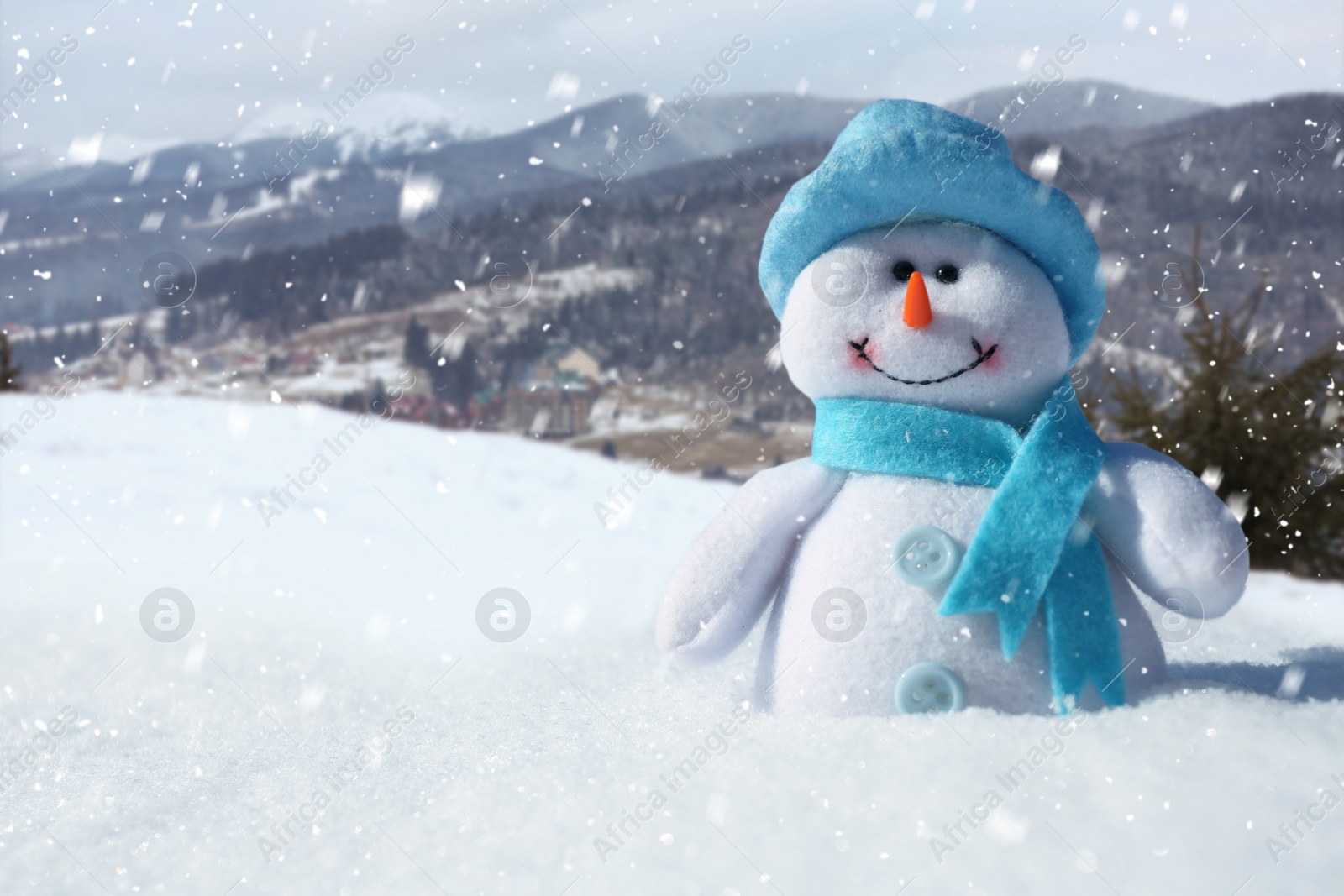 Image of Cute small decorative snowman outdoors on sunny day, space for text