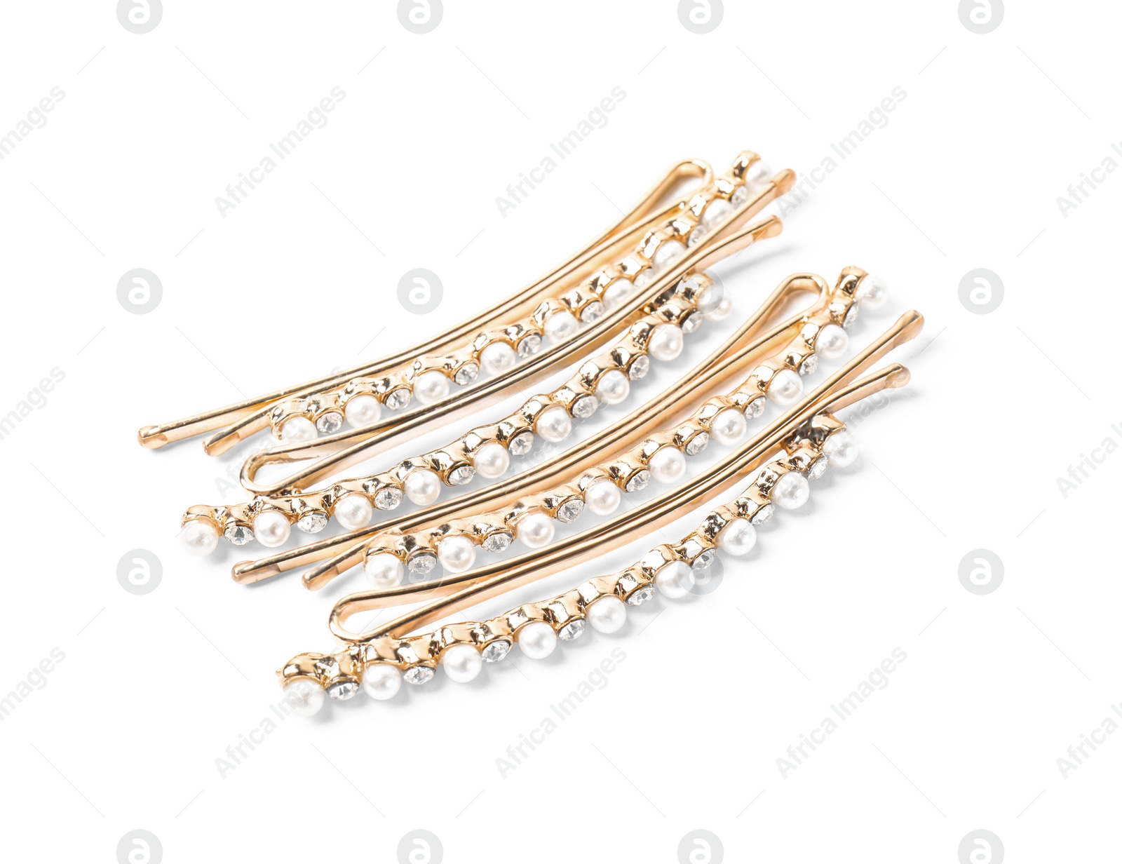 Photo of Many beautiful gold hair pins with gems on white background