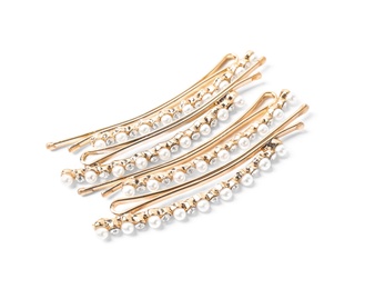 Photo of Many beautiful gold hair pins with gems on white background