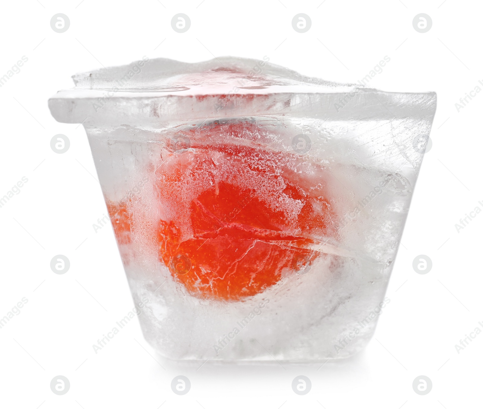 Photo of Fresh tomato in ice cube on white background. Frozen vegetables