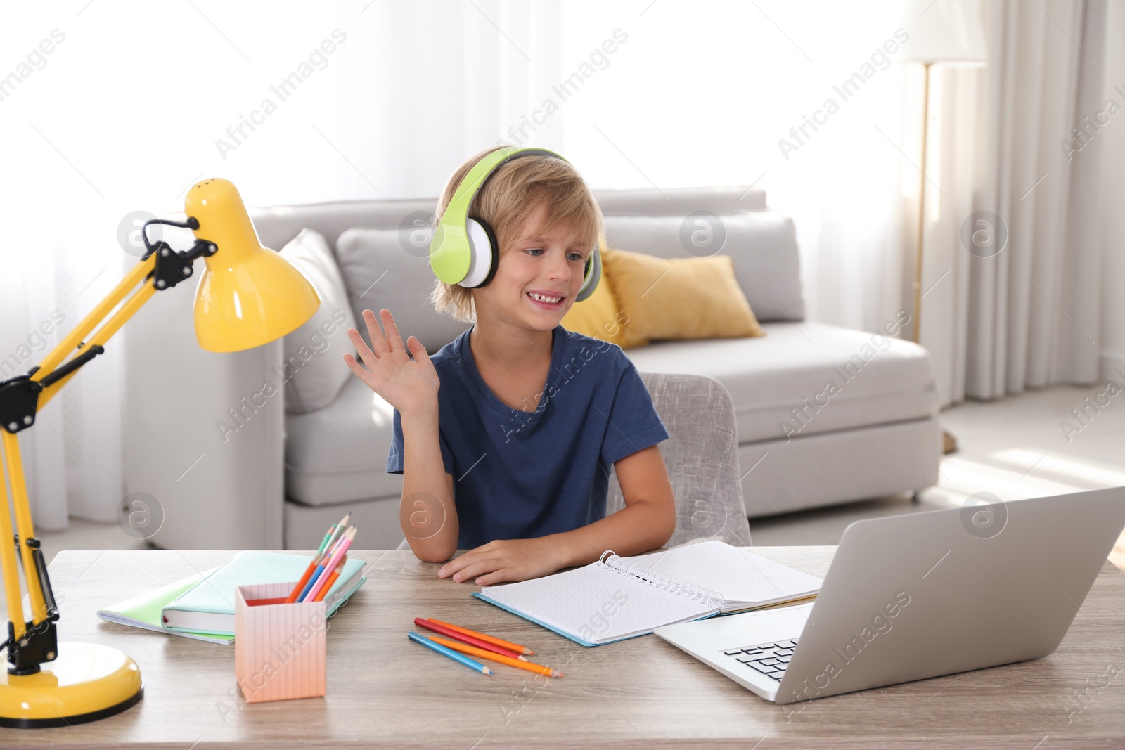 Photo of Little boy studying online at home. Distance learning during COVID-19 pandemic