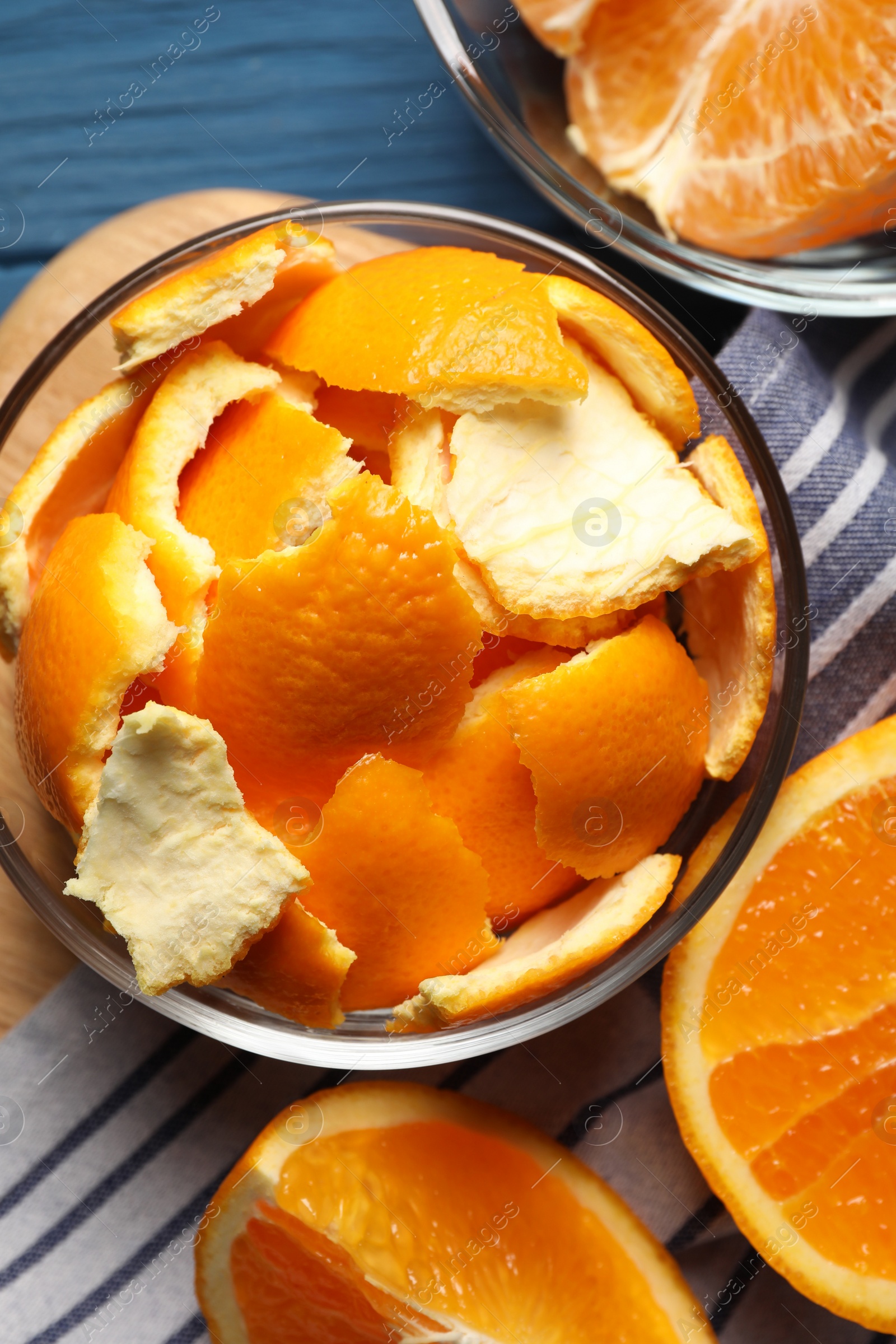 Photo of Orange peels preparing for drying and fresh fruits on blue wooden table, flat lay